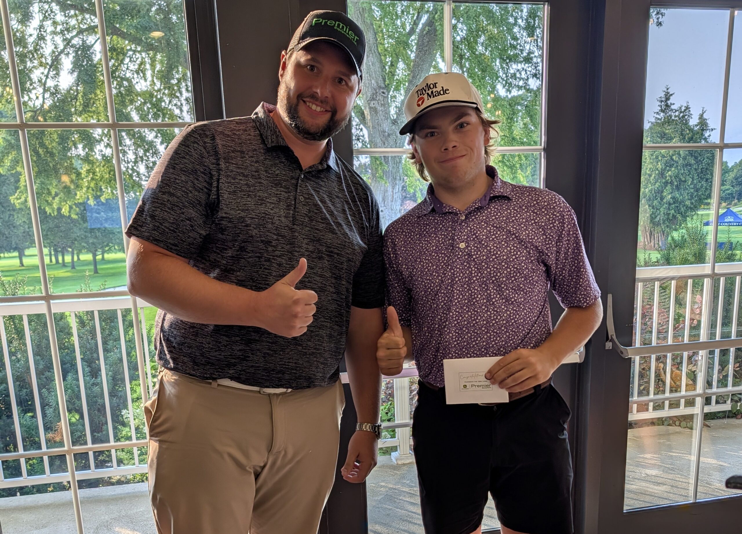 (L-R): Dan Tomas, Premier Equipment, recognizes Cohen Belore, Sunningdale G&CC, for winning the Closest to the Pin contest. 